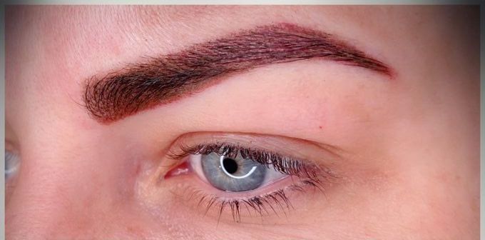 The same eyebrow straight after permanent makeup: gaps filled with fine hair-like strokes.